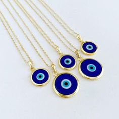 Ward off bad vibes in style with our Blue Turkish Evil Eye Necklace. Perfect for any occasion (except maybe a séance), this necklace features a stunning blue evil eye charm on a delicate chain. Keep the negativity away, all while looking fabulous. This necklace is combination of; - dark blue glass evil eye bead - stainless steel gold chain 15mm Charm Made in Turkey Blue Evil Eye Charm Necklace, Blue Amulet Charms Necklace, Spiritual Blue Charm Necklace, Spiritual Blue Evil Eye Jewelry, Blue Pendant Charm Necklaces For Spiritual Style, Blue Evil Eye Jewelry As Gift, Blue Evil Eye Jewelry Gift, Blue Amulet Jewelry With Adjustable Chain, Blue Nickel-free Pendant Charm Necklaces