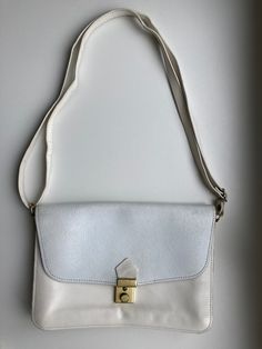 "♥ Vintage white crossbody bag, 2 compartments and 1 pocket inside and 1 pocket outside. ♥ Beautifully engraved front flap with floral botanical pattern.  ♥ At least partly genuine leather. ♥ Adjustable strap. ♥ There is some leather wear and discolorations inside and outside (see the photos).  Measurements: - width 9.9\" / 25cm - height 7.1\" / 18cm - depth 1\" / 2.5cm ♣ Vintage items may come with minor flaws due to pre-loved wear. Please enjoy and appreciate this item with its character. ♣ Fo White Pouch Flap Bag For Travel, Elegant White Shoulder Bag With Cell Phone Pocket, Classic White Flap Shoulder Bag, White Shoulder Bag Pouch With Cell Phone Pocket, Cream Satchel Flap Bag With Adjustable Strap, White Shoulder Flap Bag For Travel, White Shoulder Bag For Travel, Daily Use Cream Crossbody Flap Bag, White Travel Satchel With Cell Phone Pocket