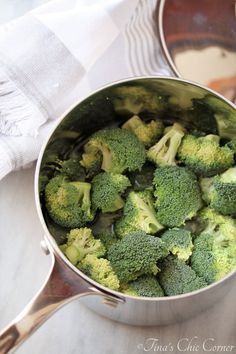 broccoli florets are being cooked in a pot