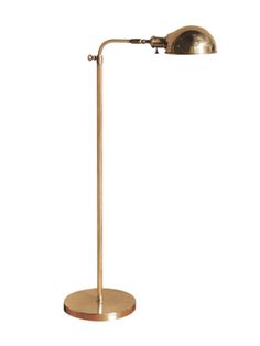 a brass plated floor lamp on a white background