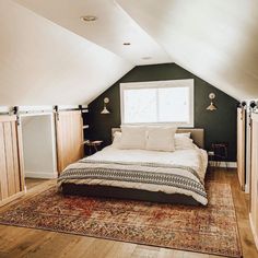 a bed sitting in the middle of a bedroom on top of a rug