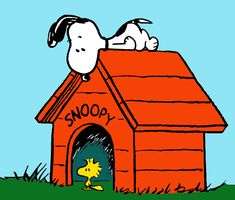 a snoopy dog house with the door open and his head sticking out from it