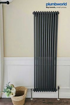 a radiator in the corner of a room next to a basket with flowers