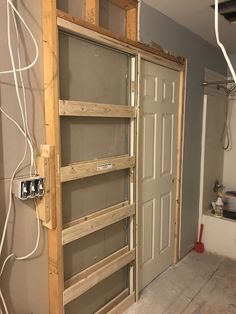 the inside of a house being remodeled with wood framing and metal door frames in place