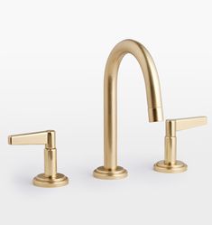 two gold faucets with handles on each side