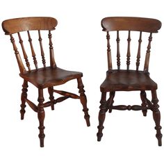 two wooden chairs side by side on a white background