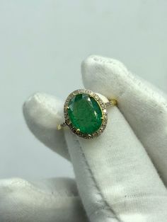 Luxury Yellow Gold Oval Emerald Ring, Oval Cut Emerald Ring, Oval Yellow Gold Emerald Ring With Halo, Oval Emerald Ring Stamped 14k, Oval Emerald Ring Stamped 14k Gold, Oval Hallmarked Emerald Ring Fine Jewelry, Oval Hallmarked Emerald Ring In Fine Jewelry Style, Hallmarked Oval Emerald Ring In Fine Jewelry Style, Fine Jewelry Hallmarked Oval Emerald Ring