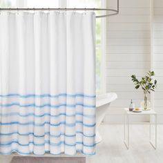 a white and blue shower curtain in a bathroom