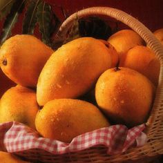 a basket filled with lots of oranges on top of a table