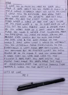 a note written on lined paper next to a pen