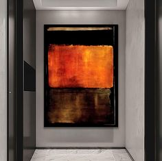 an abstract painting hangs in the corner of a room