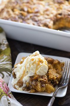 a piece of pie with ice cream on top and a fork next to the plate