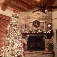 a decorated christmas tree in front of a fireplace