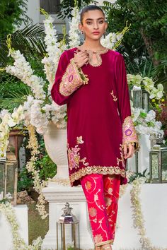 Elegant and sophisticated, this crimson shade is cut from the softest velvet into an effortless box-cut silhouette. The kurta is worked with embroidered floral patterns, embellishments and finished with scalloped edges. The cut out neckline and heavily embellished cuffs on the sleeves offset the piece beautifully. The Fitted Kurta With Embroidered Sleeves, Eid Blouse With Embroidered Sleeves, Traditional Embellished Velvet Dress, Elegant Velvet Dress With Dabka Work, Elegant Velvet Dress With Intricate Embroidery, Fitted Velvet Kurta For Wedding, Party Kurta With Embroidered Long Sleeves, Festive Long Sleeve Kurta With Embroidered Sleeves, Velvet Long Sleeve Kurta For Party