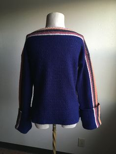 "1970s pullover long sleeve knit sweater label- Susie's 60% acrylic, 20% wool, 20% mohair made in Italy deep blue w/multi-color striped detail xtra long sleeves 2 front pockets soft and fuzzy light age wear, light pilling label size L actual measurements, lying flat, shoulder-22\" shoulder to sleeve (cuffed)-23\" chest-20\" length-24\" original one of a kind with an retro art deco style fisher(wo)man vibe" Striped Wool Sweater With Long Sleeves, Winter Long Sleeve Sweater With Striped Cuffs, Long Sleeve Cardigan With Striped Cuffs For Fall, Fall Cardigan With Striped Cuffs And Long Sleeves, Blue Winter Sweater With Striped Cuffs, Casual Wool Sweater With Striped Cuffs, Winter Long Sleeve Cardigan With Striped Cuffs, Long Sleeve Cardigan With Striped Cuffs For Winter, Winter Cardigan With Striped Cuffs And Long Sleeves