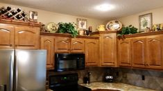 a kitchen with wooden cabinets and stainless steel appliances