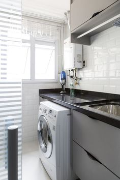 a washer sitting next to a window in a kitchen