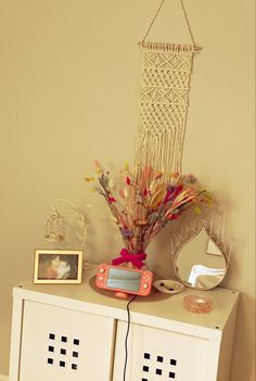 a white cabinet with flowers and pictures on it