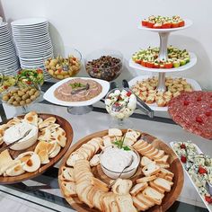 an assortment of appetizers and snacks are on display at a buffet style party