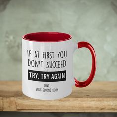 a red and white coffee mug with the words if at first you don't proceed try again