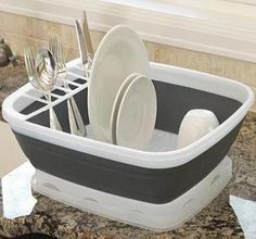 a kitchen sink with dishes and silverware in it