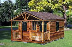 a small wooden cabin sitting on top of a lush green field