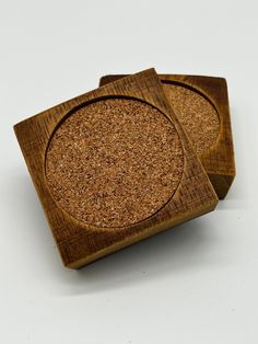 two coasters made out of wood with cork on the top one is shaped like a circle