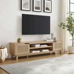 a living room scene with focus on the entertainment center and large screen tv mounted above it