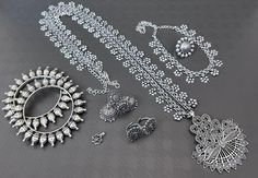 This traditional silver choker set is handmade with the best German silver, consisting of a long Haram neckpiece, a silver choker, a pair of earrings, bangles, and a nose pin. The long neckpiece has a bold geometrical pendant with a floral design, chained with ghungroos all around. Get yourself this bold statement jewellery set available in four different patterns and make your ethnic or western outfit look gorgeous and pepped up! We have handcrafted these products by experts to ensure you an ex Festive Bohemian Silver Choker, Elegant Silver Multi-strand Choker, Bohemian Dual-tone Silver Necklace, Heavy Silver Bohemian Choker, Bohemian Silver Multi-strand Crystal Necklaces, Bold Statement Jewelry, German Silver Jewelry, Flower Choker, Silver Choker