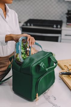 "Our professional tote in callaloo green with a cognac interior is ready to hit the streets! The two compartment design on our vegan leather lunch bag allows for you to proudly travel with your lunch in a way that matches your personal style. The vegan leather tote is hand sewn and is perfect for carrying both hot and cold items in the insulated sections. It also comes with a removable shoulder strap. Long Term Thermal Insulation - Double layered insulation provides excellent protection to your Lunch Bag Photography, Lunch Bags For Women To Work, Women’s Lunch Bag, Large Capacity Green Lunch Bag For Travel, Aesthetic Lunch Bags, Lunch Bag Aesthetic, Luxury Lunch Bags, Green Large Capacity Lunch Bag, Practical Green Rectangular Lunch Bag