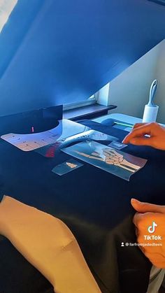 a person is sitting at a desk with some papers on it and an air plane wing in the background