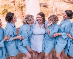 a group of women standing next to each other in blue robes