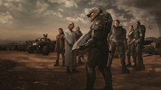 a group of people standing around each other in front of an image of the halo logo