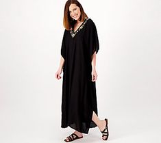 Luxurious and soft, with a stunning amount of hand-beaded and embroidered embellishments, this stunning caftan will take you from lounge to lunch in an instant. From America & Beyond. Beaded Dresses For Vacation, Spring Embroidered Maxi Length Kaftan, Spring Embellished Kaftan, Spring Maxi Kaftan With Embroidered Border, Elegant Embroidered Kaftan For Vacation, Traditional Embellished Dresses For Vacation, Summer Embellished Tunic, Maxi Kaftan With Embroidered Neckline, Beach Maxi Dress With Embroidered Hem