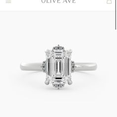 an emerald cut diamond ring with diamonds around it