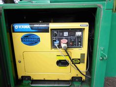 a yellow and green machine sitting in the back of a truck