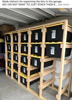 the shelves are filled with black containers and some yellow plastic bins on top of them