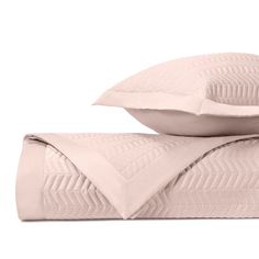 two pillows and one pillow on top of each other in front of a white background