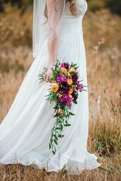 a woman in a wedding dress holding a bouquet