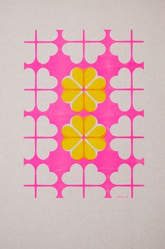 a pink and yellow design with hearts on it's center is featured in this image