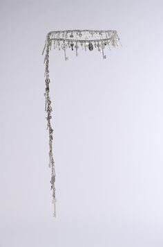 a white wall with some beads hanging from it