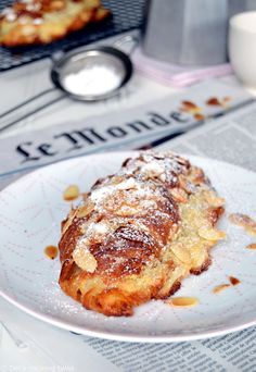 a pastry on a plate with powdered sugar