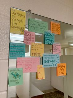 a mirror that has some post it notes on it with writing and magnets attached to it