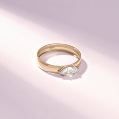 a gold ring with a single diamond on it