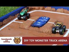 toy monster truck arena in the shape of a dirt track with two trucks on it