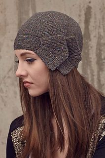 a woman with long hair wearing a knitted hat and looking off to the side