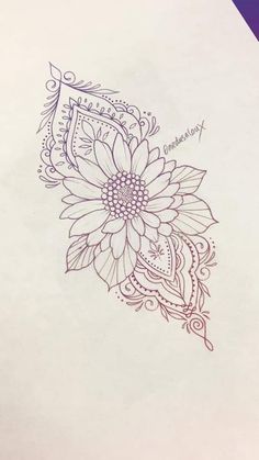 a drawing of a flower on paper with the word love written in cursive writing