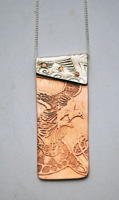 "This copper and silver Magpie necklace is made up of two etched and impressed pieces of metal and riveted together with handmade copper rivets.  The top part of this copper and silver Magpie pendant is made from sterling silver which has been impressed from an etched brass plate of my own hand drawn ink drawing.  The bottom part is etched with a flying magpie motif and polished to a mirror finish.  All my designs are original limited editions. supplied on sterling silver 16\" or 18\" curb chain Copper And Silver Jewelry, Etched Metal Jewelry, Rivet Jewelry, Cold Connections, Etched Jewelry, Metal Jewellery, Etched Copper, Metal Etching, Metal Clay Jewelry