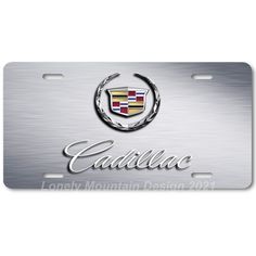 a metal license plate with the word cadillac on it and a car emblem in chrome