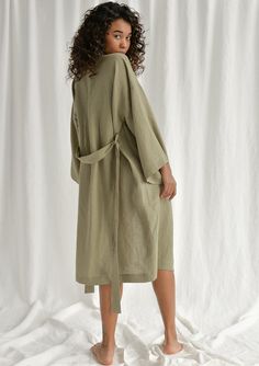 Spoil yourself with a linen bathrobe that's incredibly soft, light, and breathable. Handcrafted of premium quality European linen, this moss green kimono-style bathrobe feels so good to the skin, you'll never want to take it off. The linen robe features a relaxed fit, long sleeves, an adjustable waistband, and comfy outer pockets, making it the ultimate addition to your at-home wear. The model is 175 cm (69'') tall and is wearing a bathrobe in size S/M. DETAILS - Handmade from high-quality Europ Summer Long Linen Robe, Long Linen Summer Robe, Linen Kimono For Daywear, Relaxed Fit Linen Robe For Spring, Spring Linen Loungewear Robe, Green Spring Loungewear Robe, Green Spring Robe For Loungewear, Summer Linen Robe With Long Sleeves, Summer Linen Robe With Kimono Sleeves